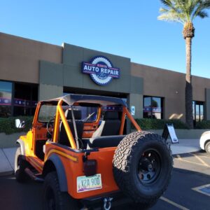 orange jeep in front of buddy's auto repair & alignment