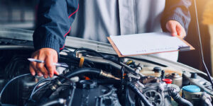 stock image of mechanic looking at an engine