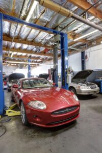 inside the bay at buddy's auto repair & alignment, up front is a red sports car